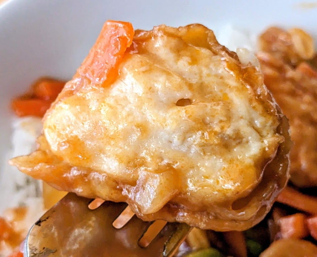 Close up of breading removed from a chunk of meat from a PF Chang's frozen Orange Chicken meal.
