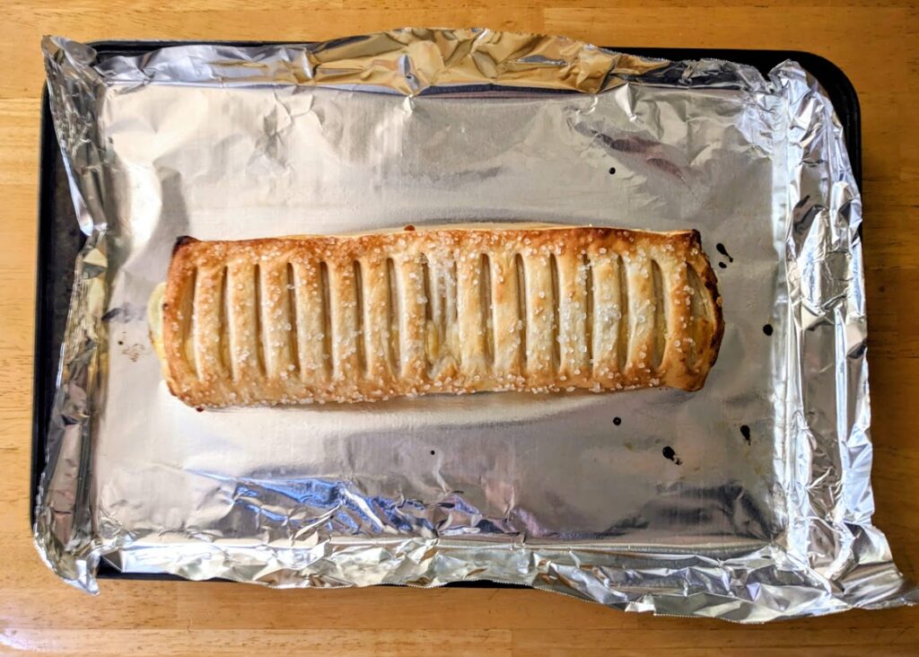 A foil-lined pan with a whole baked Lemon Mascarpone Strudel from Aldi.