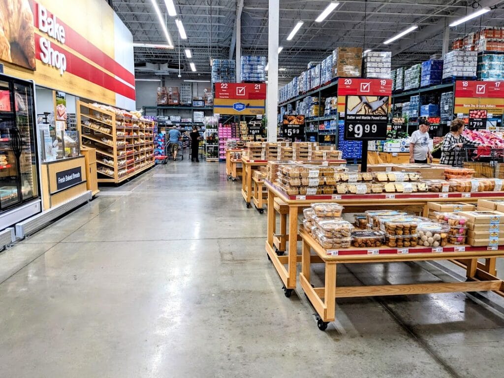 Baked goods on tables inside a BJ's Wholesale Club grocery store.