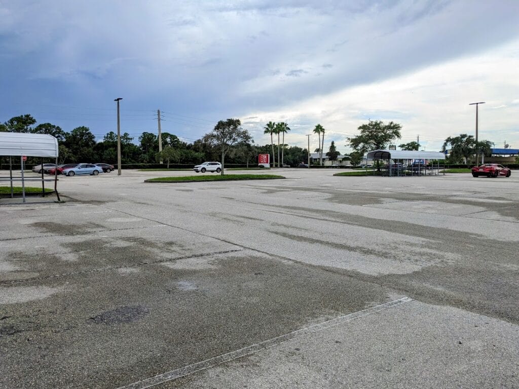 A mostly empty parking lot outside a BJ's Wholesale Club.