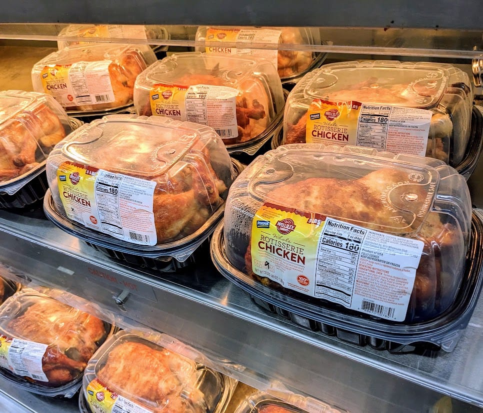Shelves of hot, boxed rotisserie chickens inside a BJ's Wholesale Club.