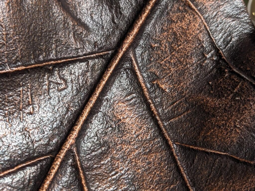 Close up of metal leaf tray, showing veining.